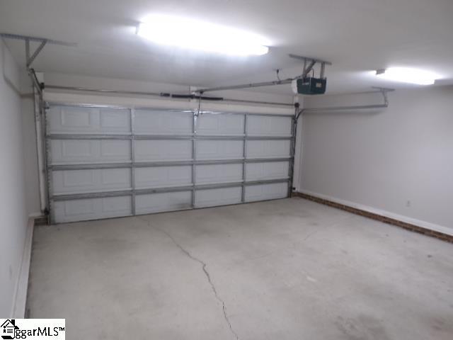 garage featuring baseboards and a garage door opener