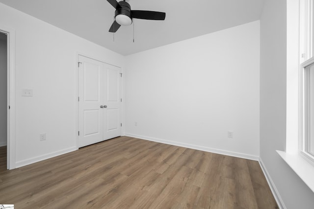 14 Polk Blvd, Greenville, SC 29611 - unfurnished bedroom with baseboards, a closet, wood finished floors, and ceiling fan
