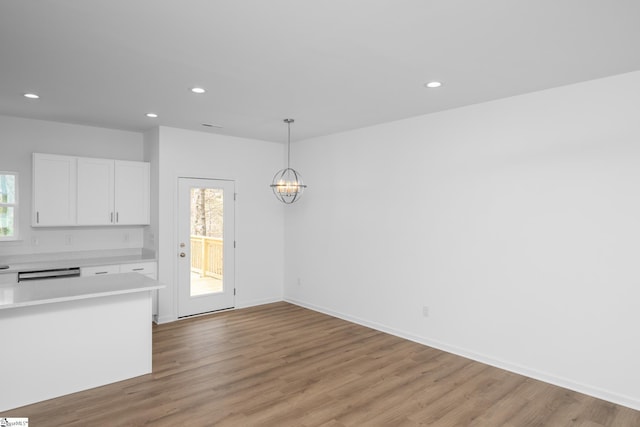 14 Polk Blvd, Greenville, SC 29611 - kitchen with light countertops, white cabinets, a chandelier, recessed lighting, and light wood-type flooring