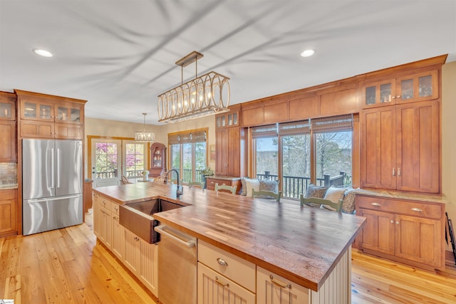 511 Palmer Way, Sunset, SC 29685 - kitchen featuring stainless steel appliances, wooden counters, a sink, an island with sink, and light wood finished floors