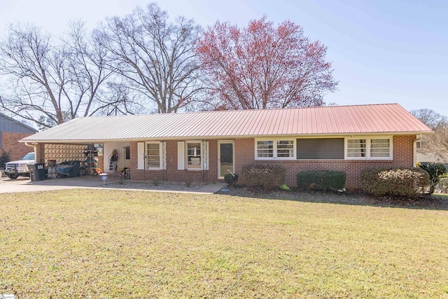 ranch-style home featuring an attached carport, metal roof, brick siding, and a front yard