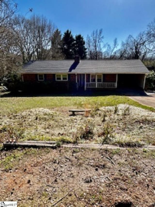 single story home with a front yard, driveway, and a carport