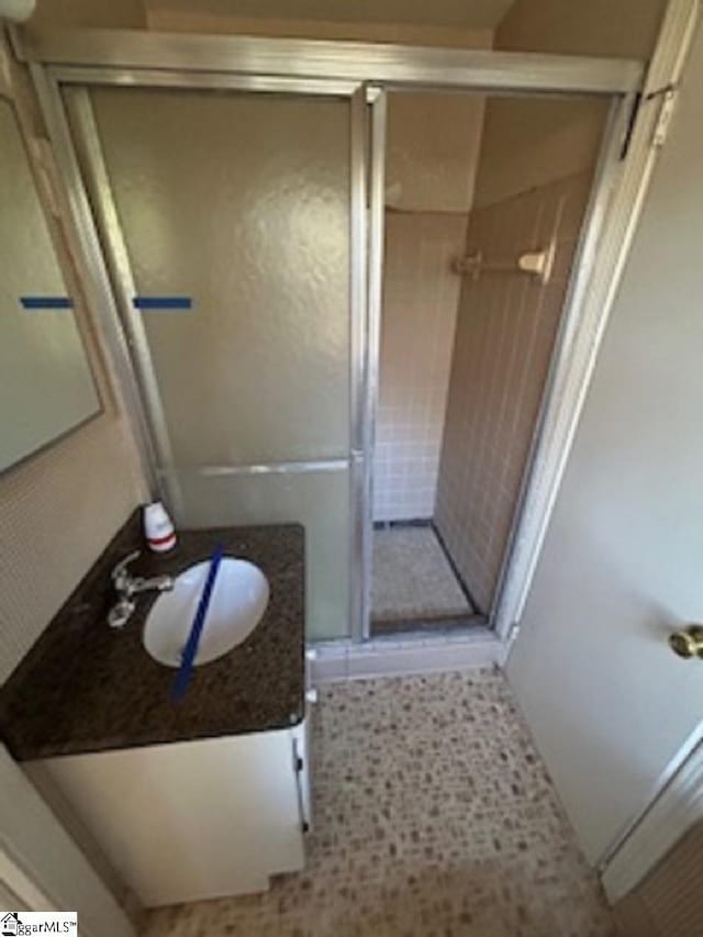full bath with tile patterned flooring, vanity, and a shower stall