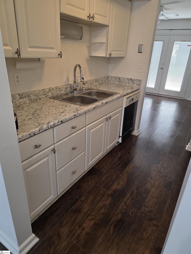 kitchen featuring dark wood-style flooring, white cabinets, ceiling fan, a sink, and dishwashing machine