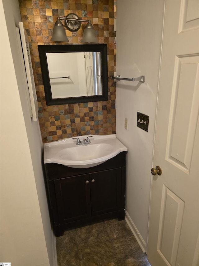 bathroom featuring vanity and tasteful backsplash