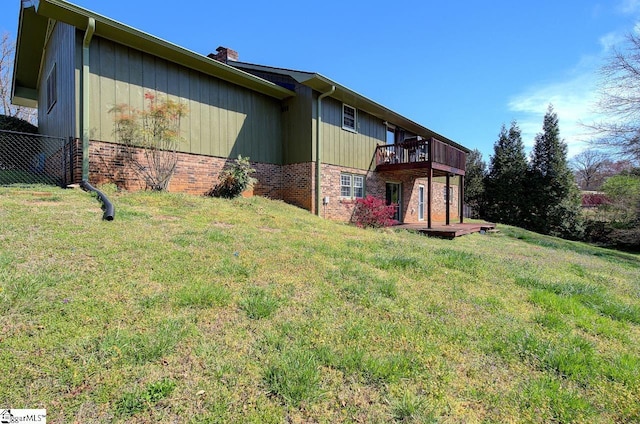 411 Westcliffe Way, Greenville, SC 29611 - view of side of property with a chimney, a wooden deck, fence, brick siding, and a lawn