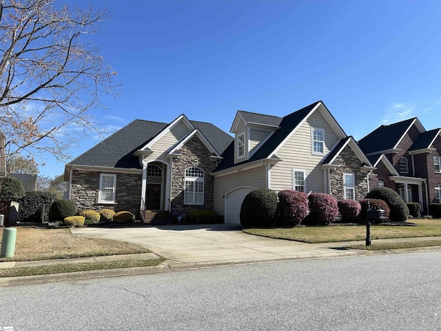 view of front of home featuring driveway and stone siding