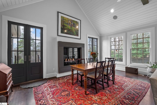 dining space featuring baseboards, wooden ceiling, wood finished floors, and french doors