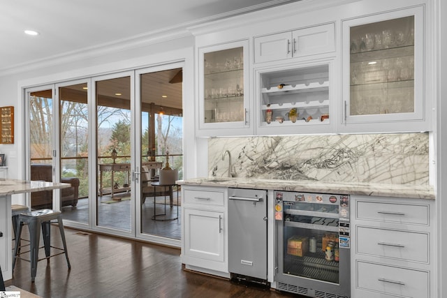 bar with crown molding, wine cooler, a sink, and tasteful backsplash