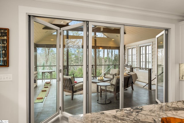 interior space with crown molding and a ceiling fan