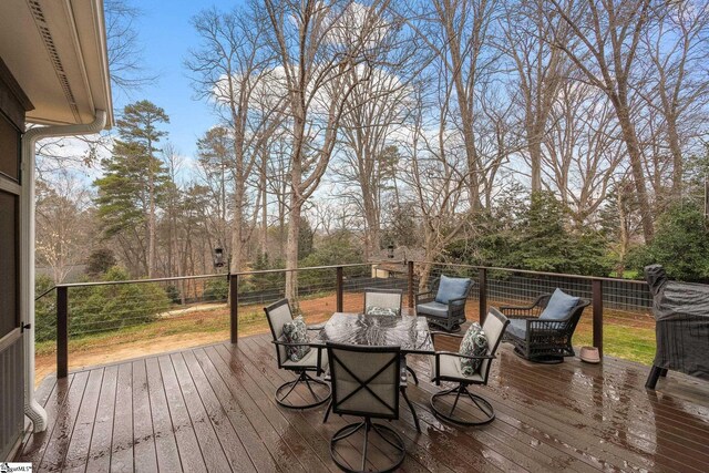 wooden terrace featuring outdoor dining space
