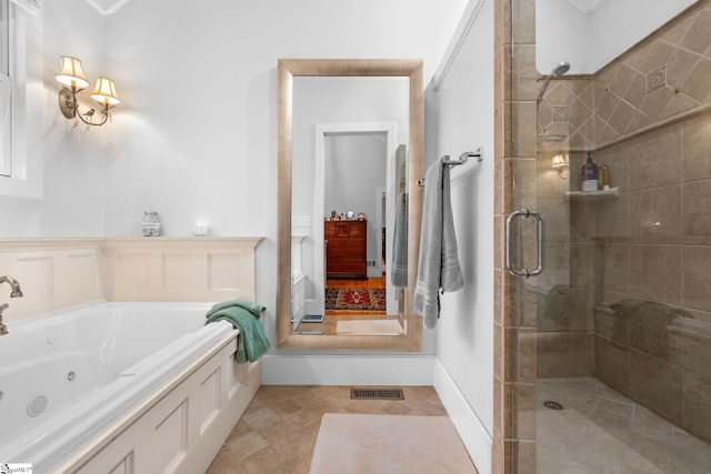 bathroom featuring a tub with jets, visible vents, and a stall shower