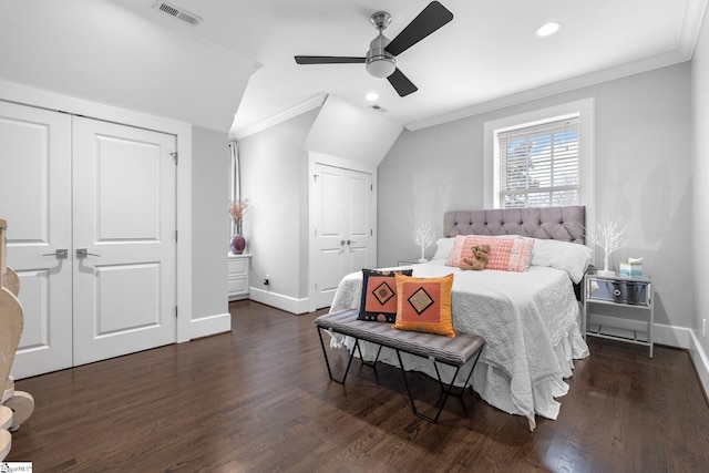 bedroom with visible vents, crown molding, and two closets