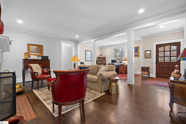 living area with recessed lighting, a fireplace, crown molding, and dark wood-type flooring