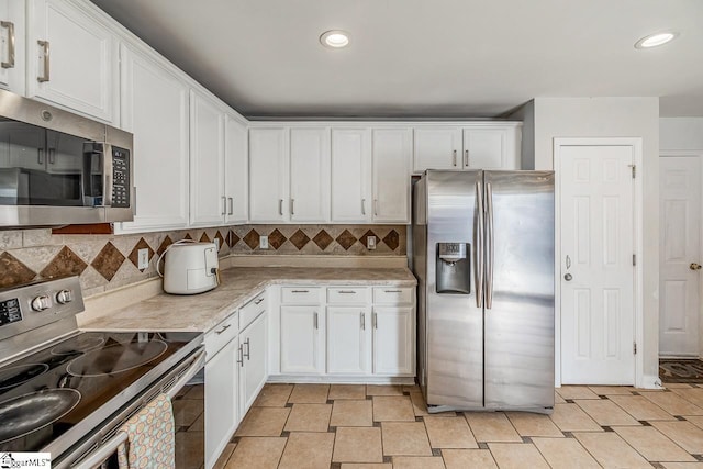 kitchen with white cabinets and appliances with stainless steel finishes