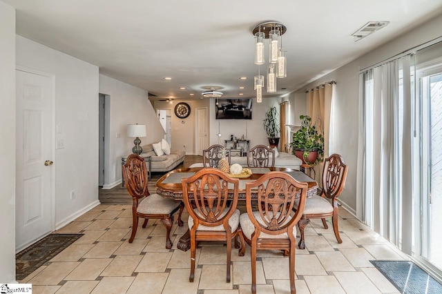 dining space featuring light tile patterned floors, baseboards, and visible vents
