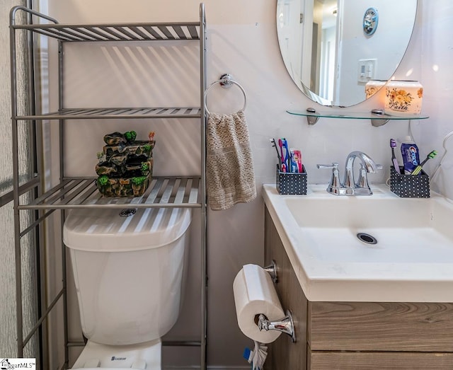 half bathroom with toilet and vanity