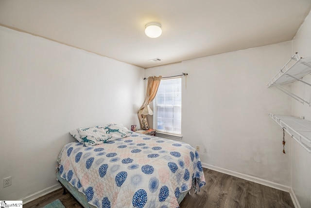 bedroom with baseboards and wood finished floors