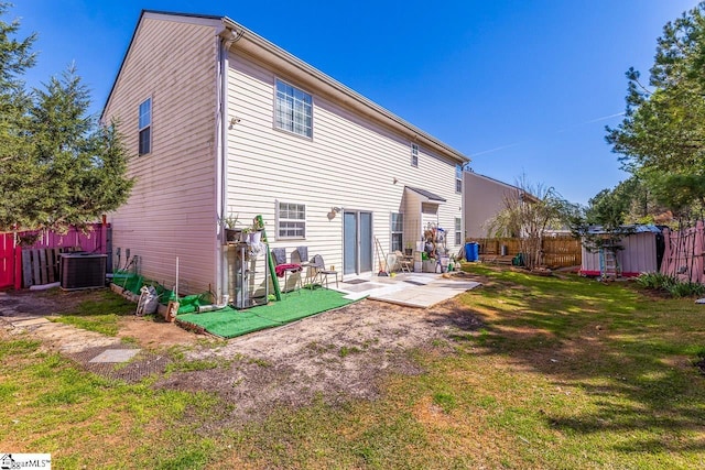 back of property featuring a patio, fence, central AC, and a yard