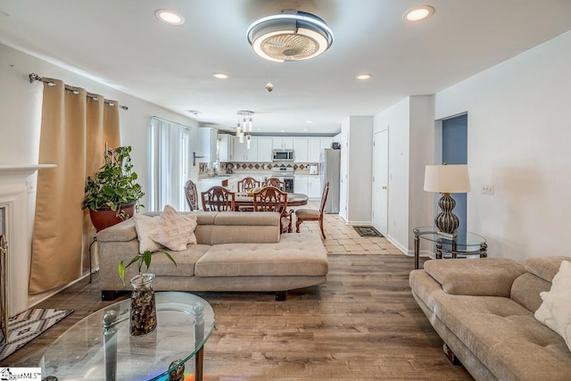 living area featuring wood finished floors and recessed lighting