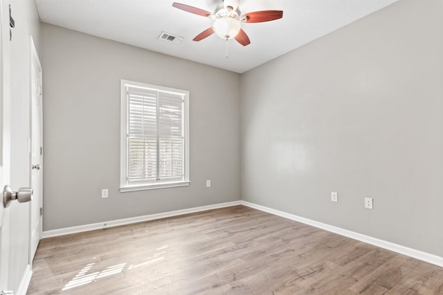 unfurnished room featuring light wood finished floors, baseboards, ceiling fan, and visible vents