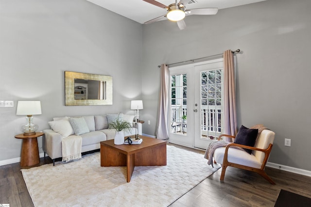 living room with baseboards, wood finished floors, and a ceiling fan