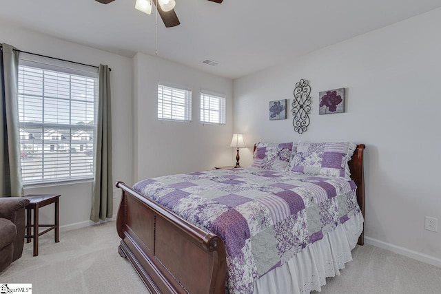 bedroom with baseboards, light colored carpet, and visible vents