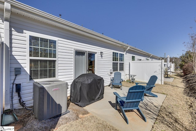 view of patio / terrace featuring cooling unit, fence, and a grill