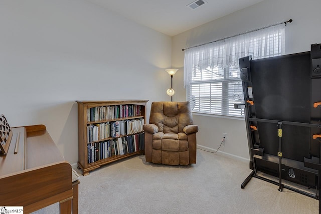 living area with carpet floors, baseboards, and visible vents
