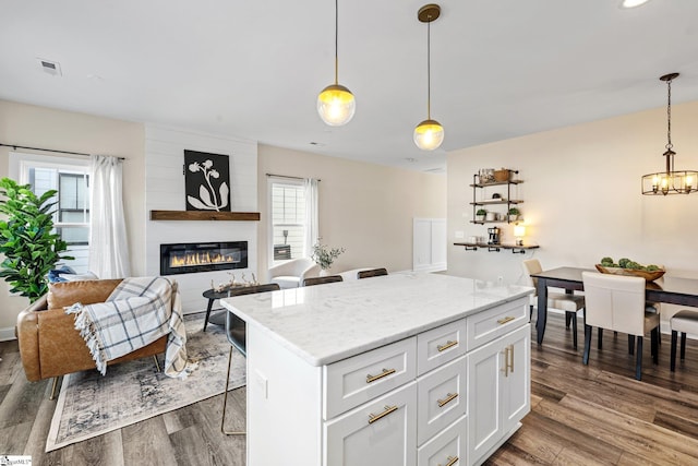 130 Park Ave, Greer, SC 29651 - kitchen featuring a center island, dark wood-style floors, visible vents, and white cabinetry
