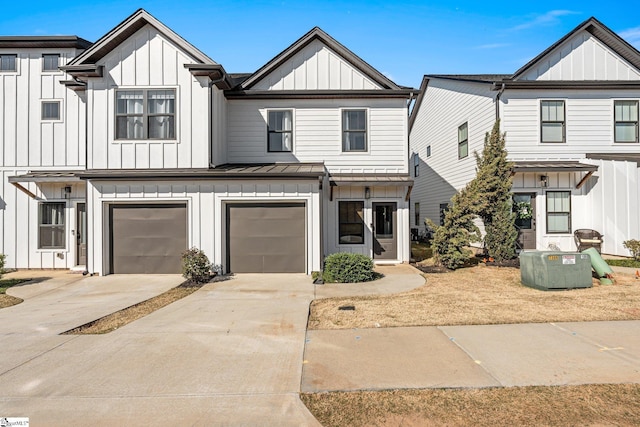 130 Park Ave, Greer, SC 29651 - view of front of house featuring a standing seam roof, an attached garage, board and batten siding, and concrete driveway
