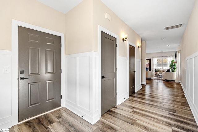 130 Park Ave, Greer, SC 29651 - entrance foyer with a decorative wall, visible vents, wainscoting, and wood finished floors