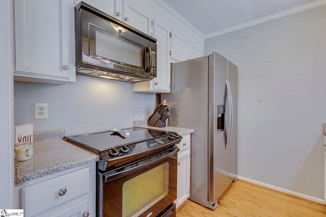 kitchen with white cabinetry, ornamental molding, baseboards, light wood-style flooring, and black appliances