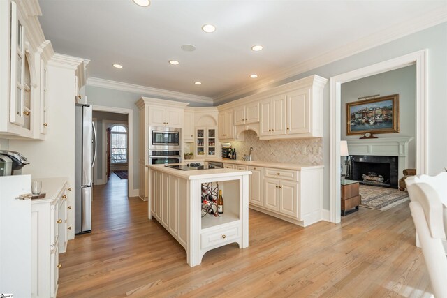6 Bentford Ct, Simpsonville, SC 29681 - kitchen featuring light wood finished floors, light countertops, decorative backsplash, and appliances with stainless steel finishes
