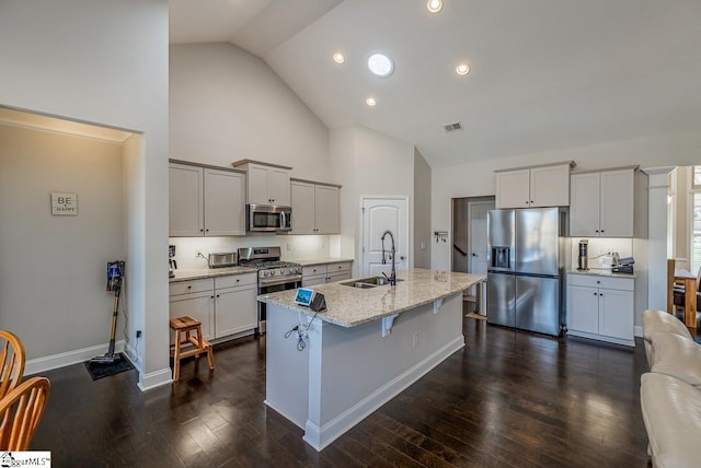 105 Cooper Oaks Ct, Simpsonville, SC 29681 - kitchen featuring stainless steel appliances, a breakfast bar, a sink, visible vents, and light stone countertops