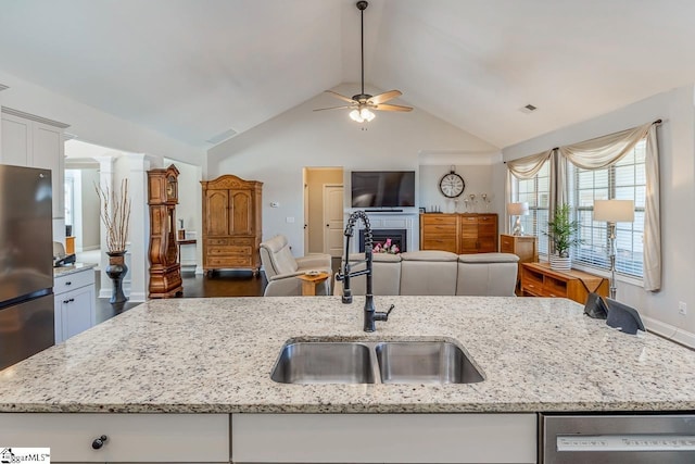 105 Cooper Oaks Ct, Simpsonville, SC 29681 - kitchen featuring open floor plan, vaulted ceiling, stainless steel appliances, a sink, and a ceiling fan
