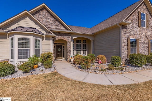 105 Cooper Oaks Ct, Simpsonville, SC 29681 - view of front of house featuring stone siding, a standing seam roof, a front lawn, and roof with shingles