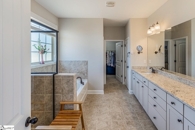 105 Cooper Oaks Ct, Simpsonville, SC 29681 - full bathroom featuring vanity, a spacious closet, tile patterned flooring, a bath, and baseboards
