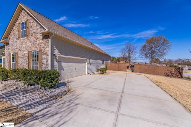 105 Cooper Oaks Ct, Simpsonville, SC 29681 - view of property exterior featuring stone siding, concrete driveway, and fence