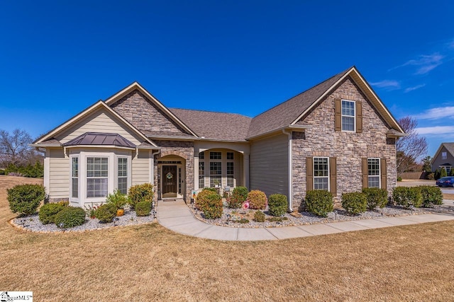 105 Cooper Oaks Ct, Simpsonville, SC 29681 - view of front of house with stone siding, metal roof, a standing seam roof, and a front lawn