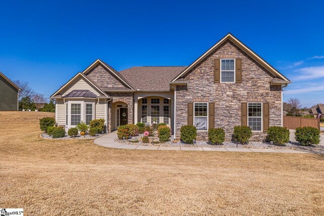 105 Cooper Oaks Ct, Simpsonville, SC 29681 - traditional-style home featuring stone siding, metal roof, a standing seam roof, and a front lawn