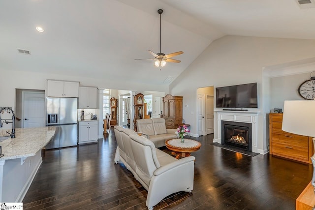 105 Cooper Oaks Ct, Simpsonville, SC 29681 - living area featuring high vaulted ceiling, dark wood-type flooring, ceiling fan, visible vents, and a glass covered fireplace