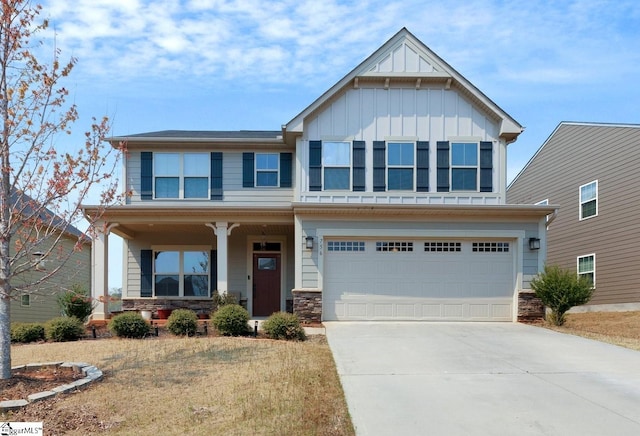 craftsman-style house with concrete driveway, stone siding, board and batten siding, covered porch, and a garage