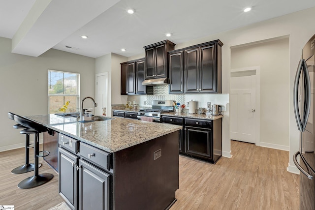 kitchen featuring light wood finished floors, a sink, visible vents, and appliances with stainless steel finishes