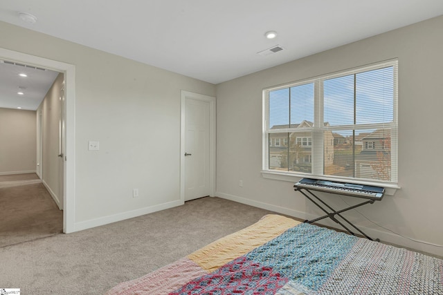 unfurnished bedroom featuring baseboards, carpet floors, and visible vents