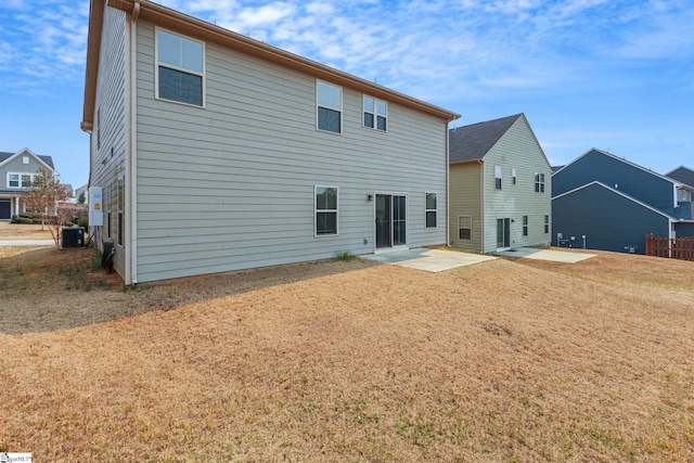back of property featuring a patio, central AC, and a yard