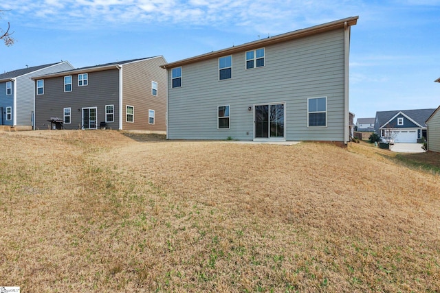 back of property featuring a lawn and a residential view