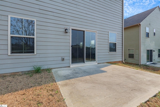 entrance to property featuring a patio area