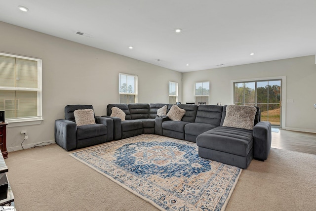 carpeted living room with baseboards, visible vents, and recessed lighting