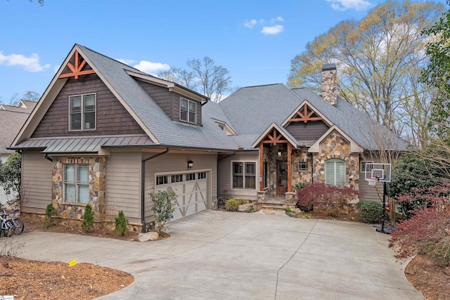 craftsman-style home with stone siding, a chimney, a garage, roof with shingles, and driveway